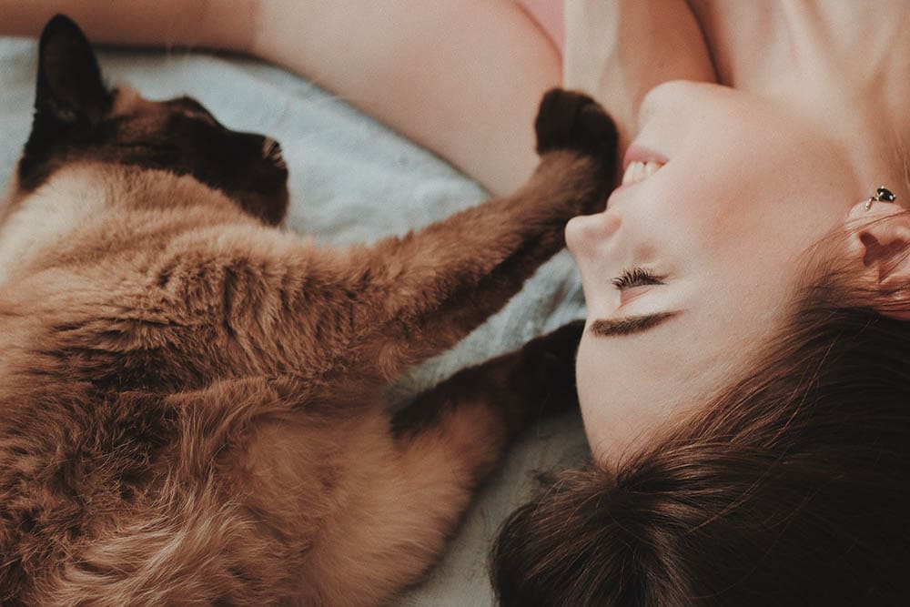 woman playing with her cat